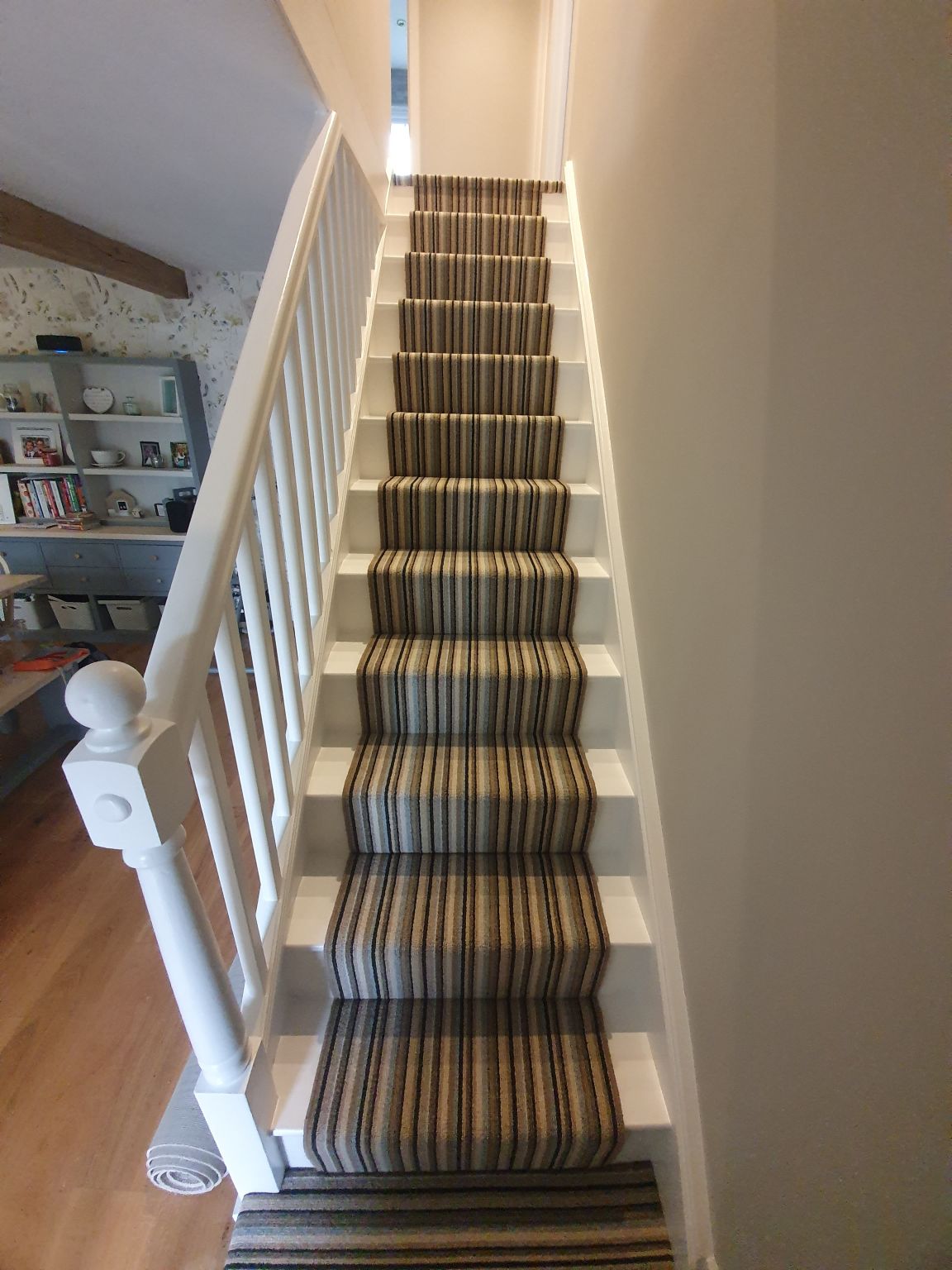 Striped carpet runner on a narrow staircase