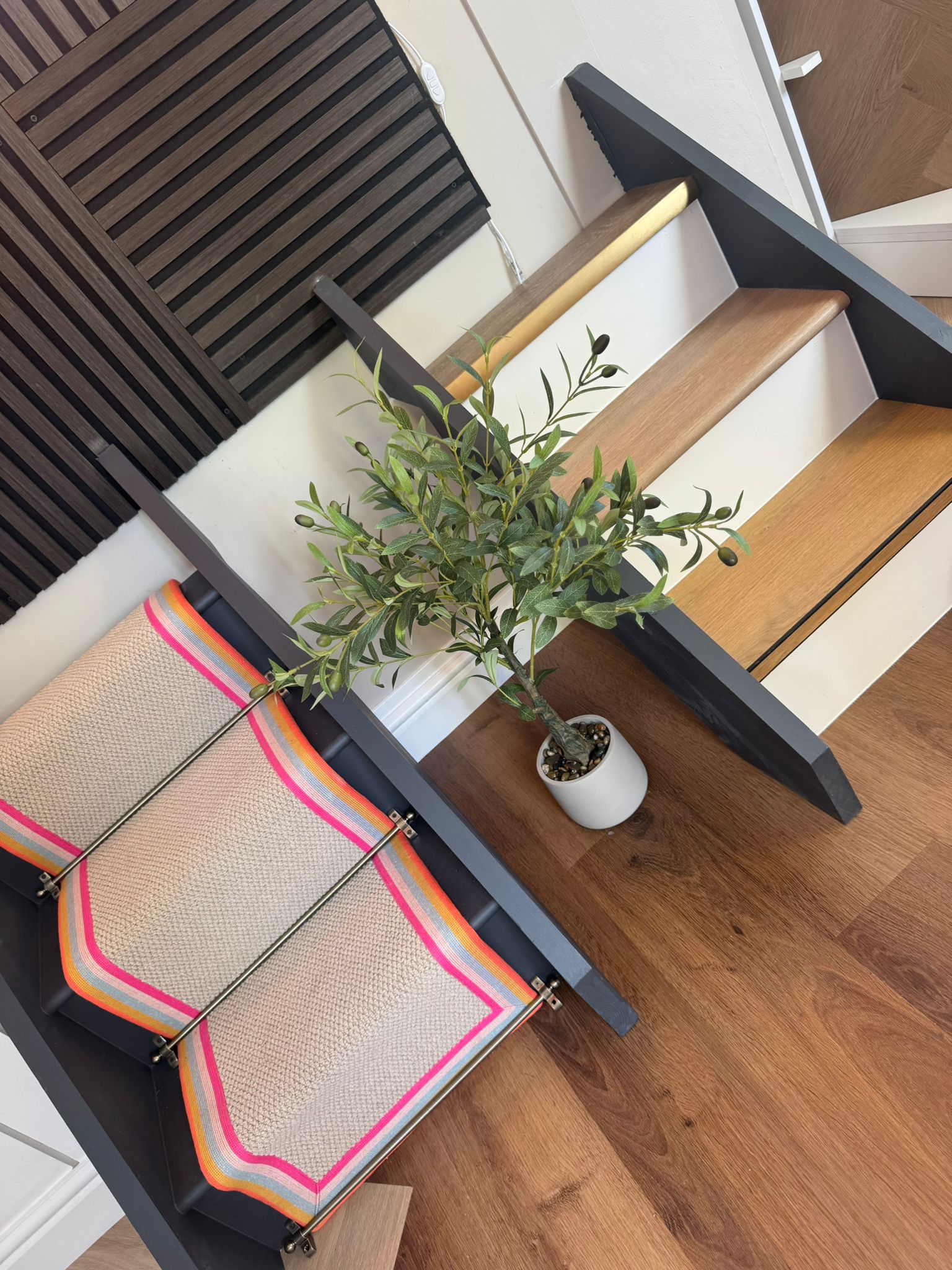 Wood floor at the foot of a staircase