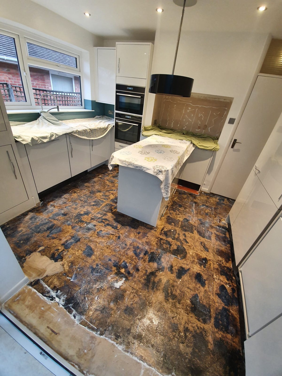 Kitchen with the old floor stripped back