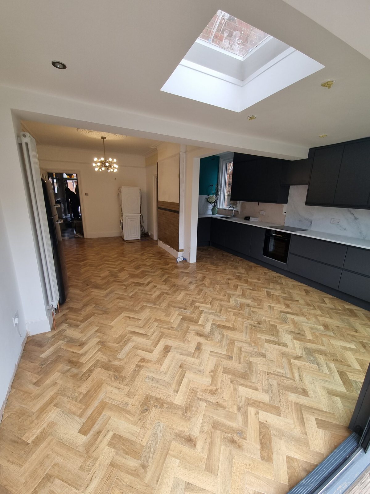 Light oak herringbone floor in a kitchen-diner