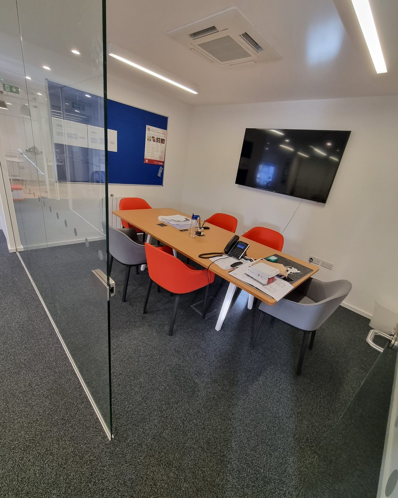 Glass-walled meeting room with new carpet