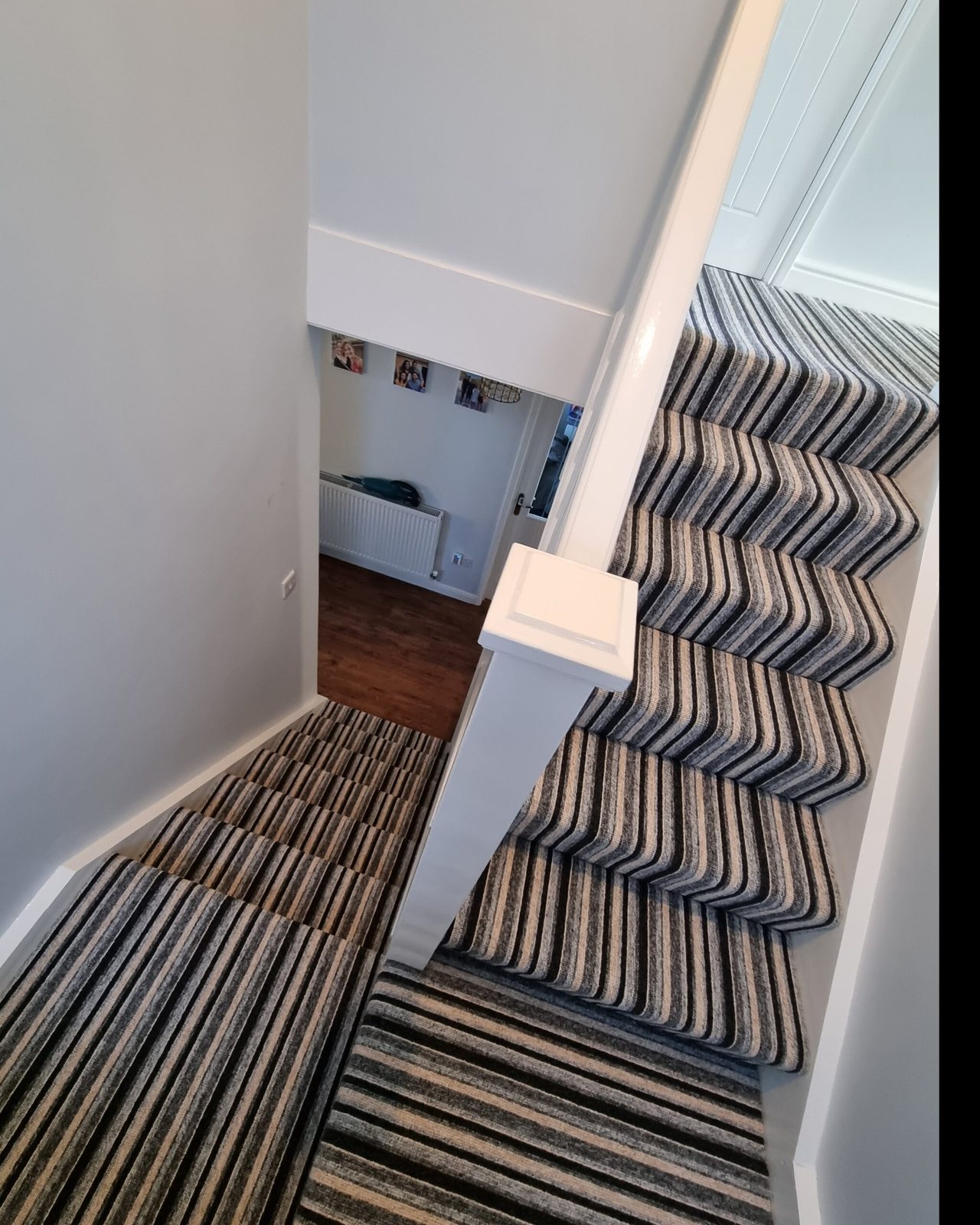 Striped carpet fitted on a winding staircase