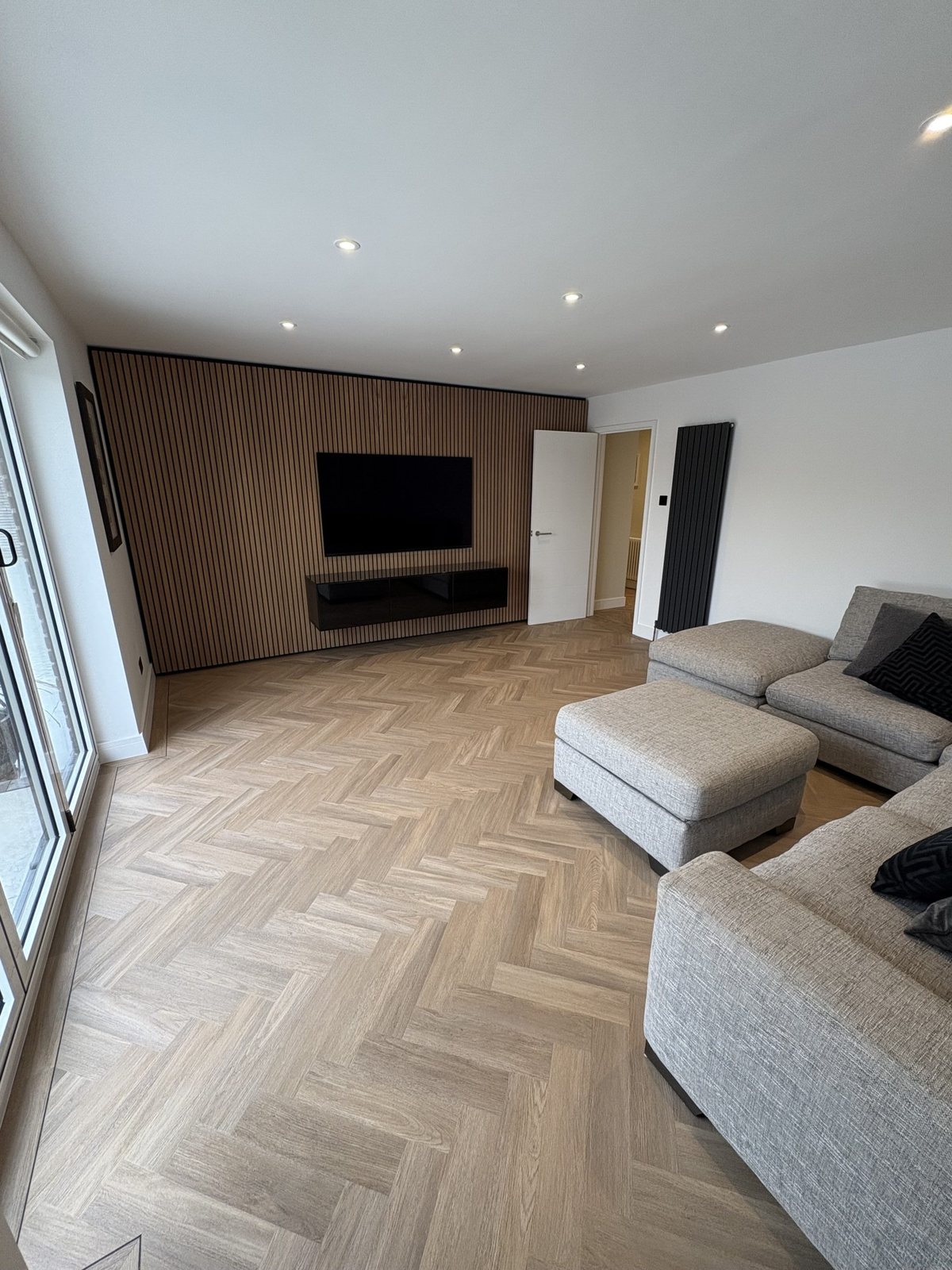 Herringbone floor in a lounge with a corner sofa